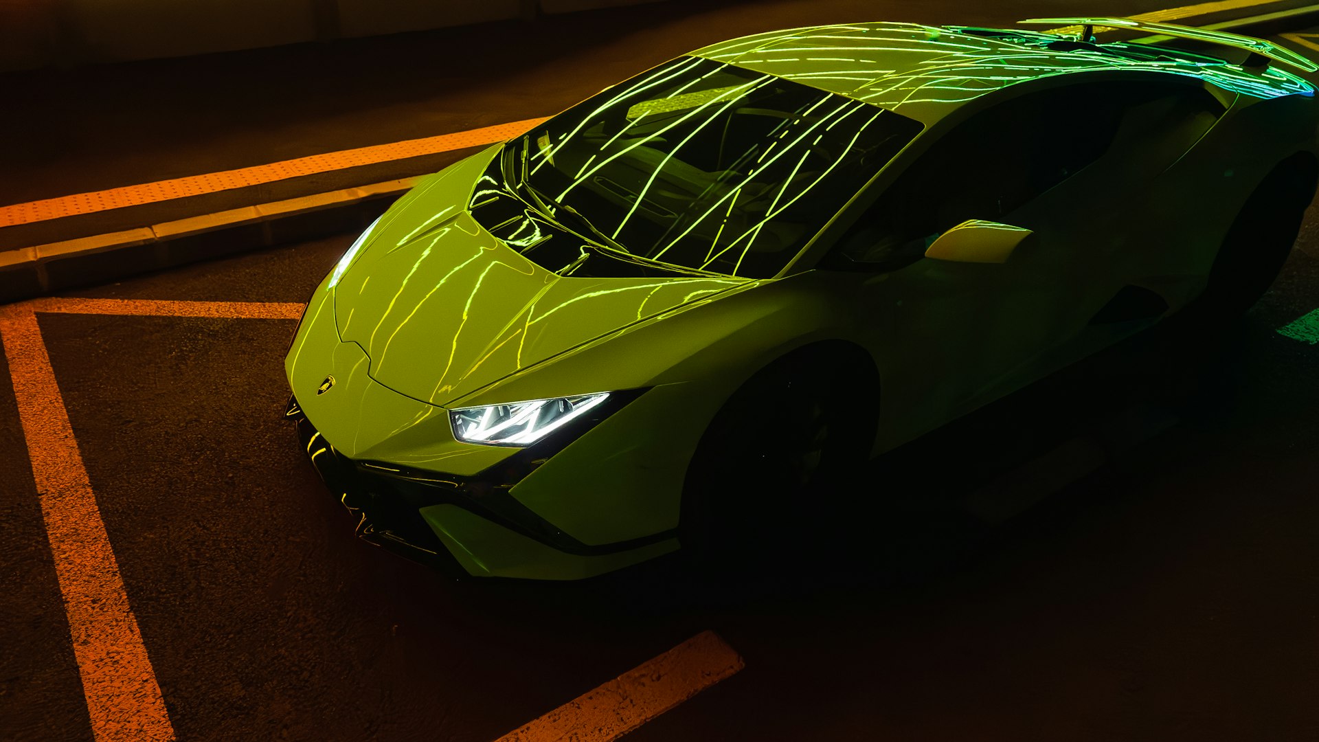a green sports car parked in a parking lot